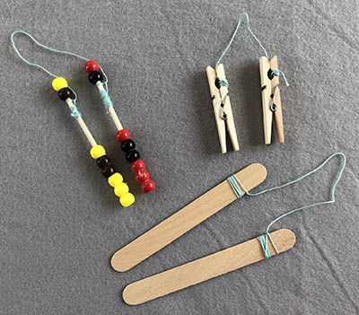 beaded bobbins, clothes pins, and popsicle sticks