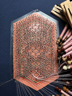working the end of a bobbin lace piece