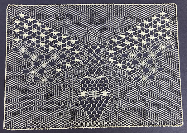 Completed bee project lace - yellow thread on a black background