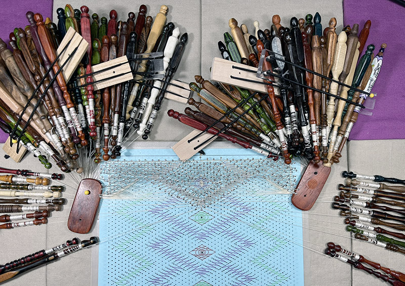 Start of the Spectral Shift sampler in silk, with 120 bobbins hung on the lace pillow.