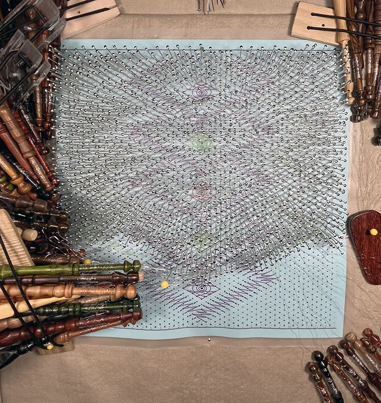 The lace is nearly complete with one final diamond section remaining, seen in regular light.