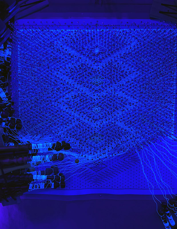 Comparison image showing the glowing UV effect on the nearly completed lace design.